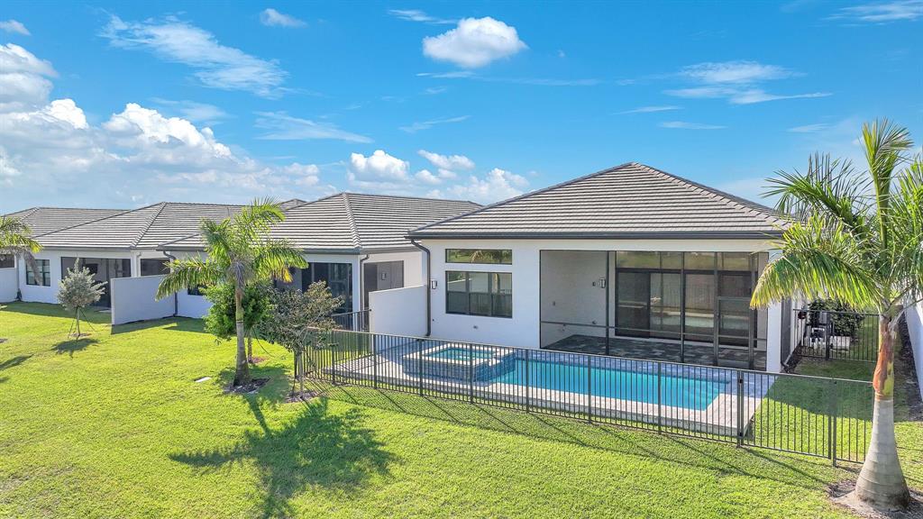 10990 Violet Mdw Street Boynton Beach, FL 33473 - Photo 29 of 60 a view of a house with swimming pool and a yard