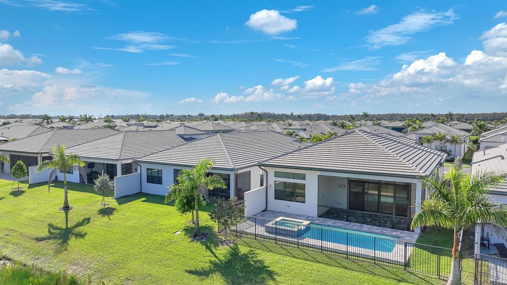 10990 Violet Mdw Street Boynton Beach, FL 33473 - Photo 30 of 60 an aerial view of a house with swimming pool and a yard