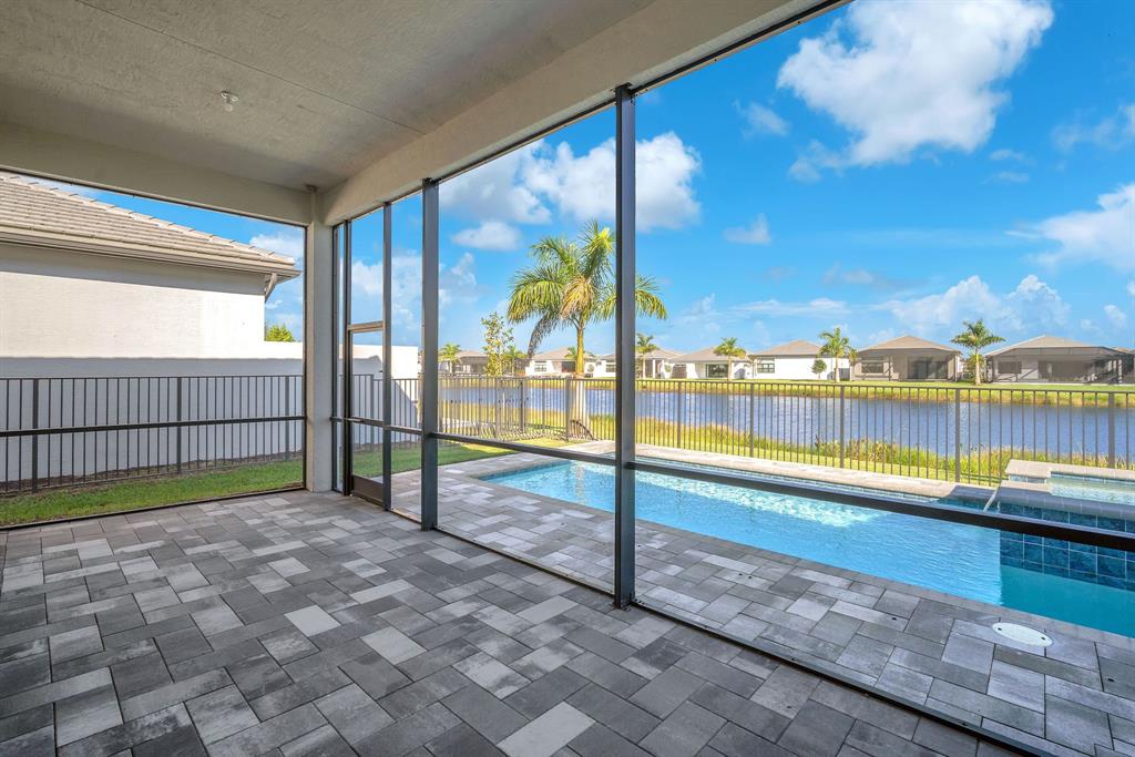 10990 Violet Mdw Street Boynton Beach, FL 33473 - Photo 38 of 60 a view of a swimming pool with a lounge chair