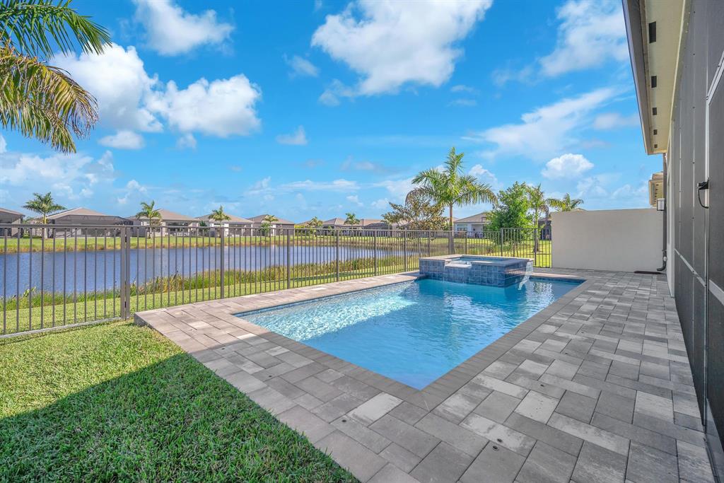 10990 Violet Mdw Street Boynton Beach, FL 33473 - Photo 4 of 60 a view of a swimming pool and an outdoor seating