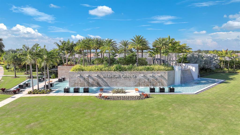 10990 Violet Mdw Street Boynton Beach, FL 33473 - Photo 43 of 60 a view of a swimming pool and a yard