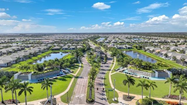 an aerial view of houses with a street