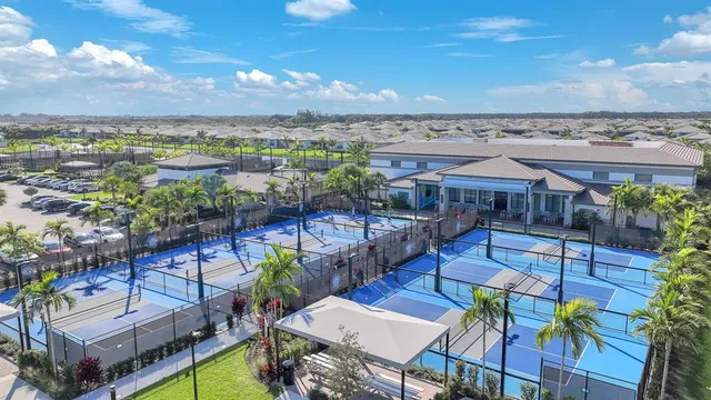 an aerial view of a city with lots of residential buildings ocean and mountain view in back