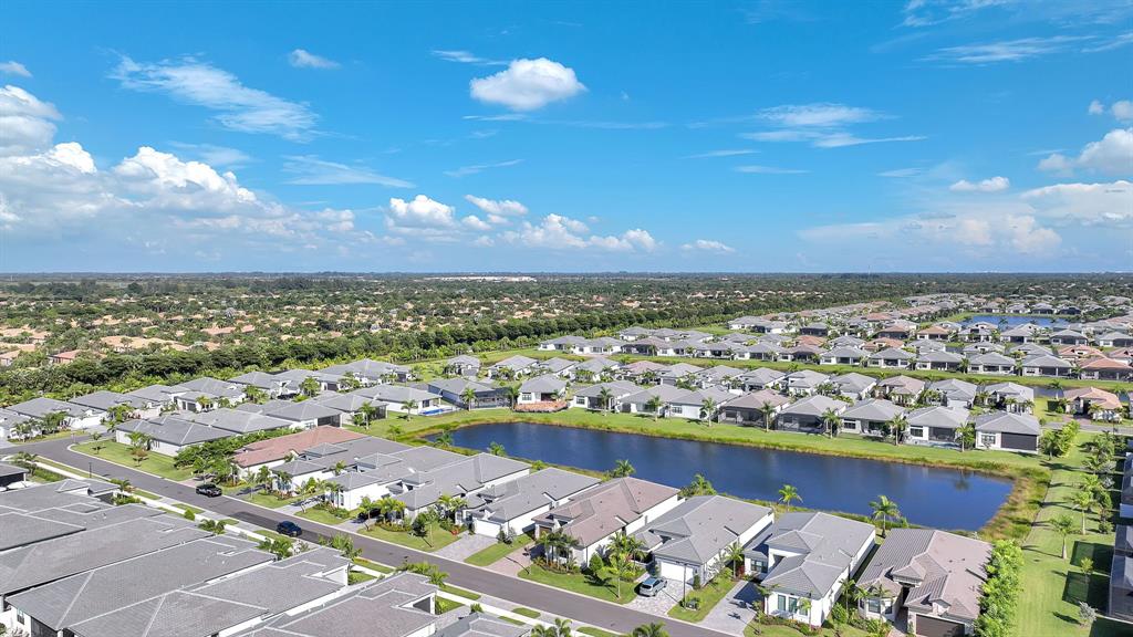 10990 Violet Mdw Street Boynton Beach, FL 33473 - Photo 57 of 60 an aerial view of a city with lots of residential buildings ocean and mountain view in back