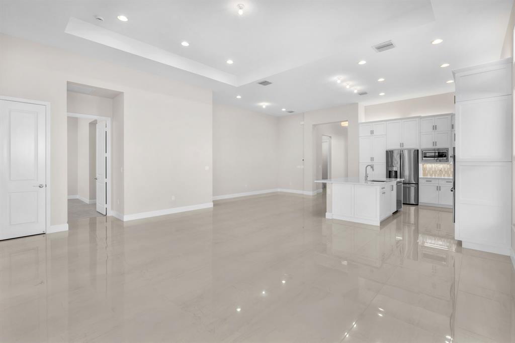 10990 Violet Mdw Street Boynton Beach, FL 33473 - Photo 6 of 60 a view of a kitchen with a refrigerator and a sink