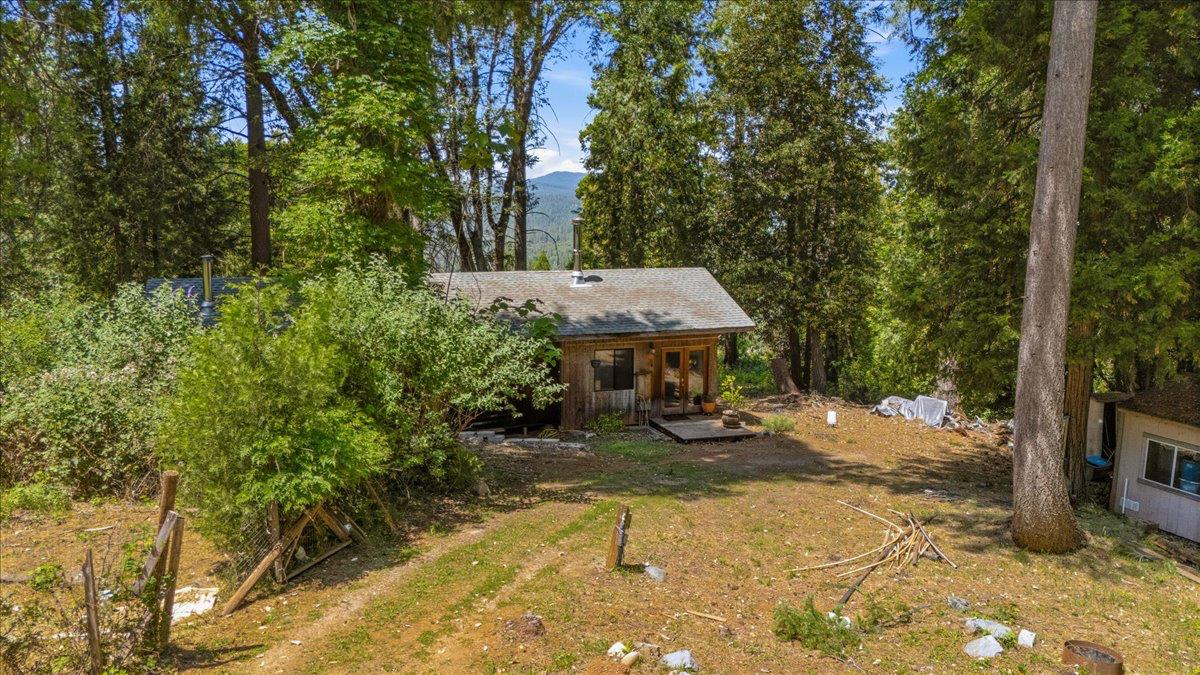 19643 Sages Road Nevada City, CA 95959 - Photo 22 of 39 a view of a wooden house with a yard