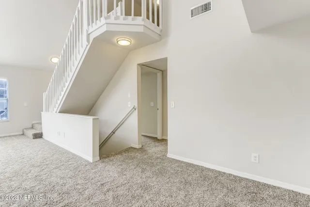 a large white kitchen with cabinets