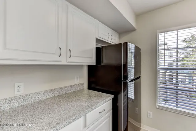 a kitchen with granite countertop a stove and a sink