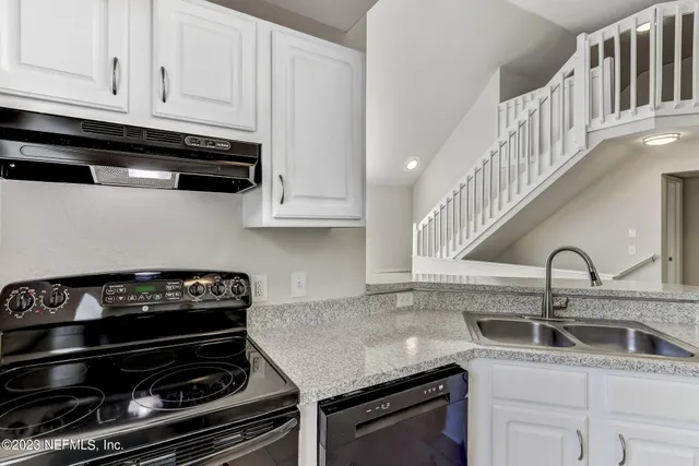 a kitchen that has a sink and a stove