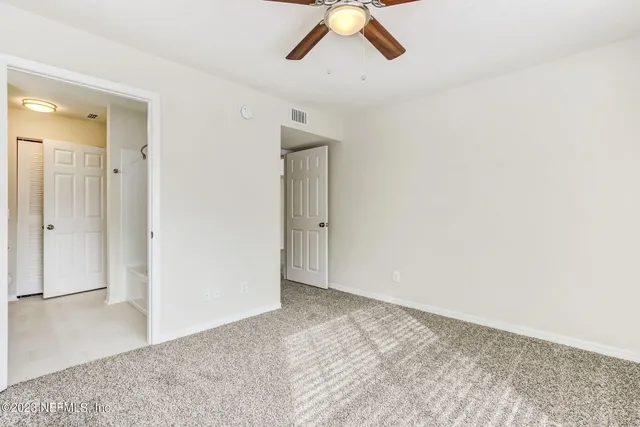 a bathroom with a granite countertop sink a mirror and a shower