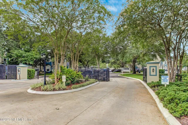 a lake view with a bench and trees