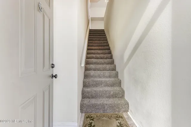 an empty room with furniture and a fireplace