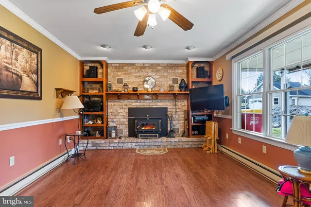 a living room with furniture fireplace and flat screen tv