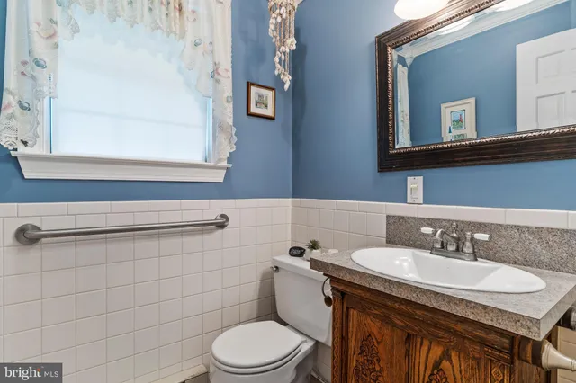 a bathroom with a sink a toilet and a mirror