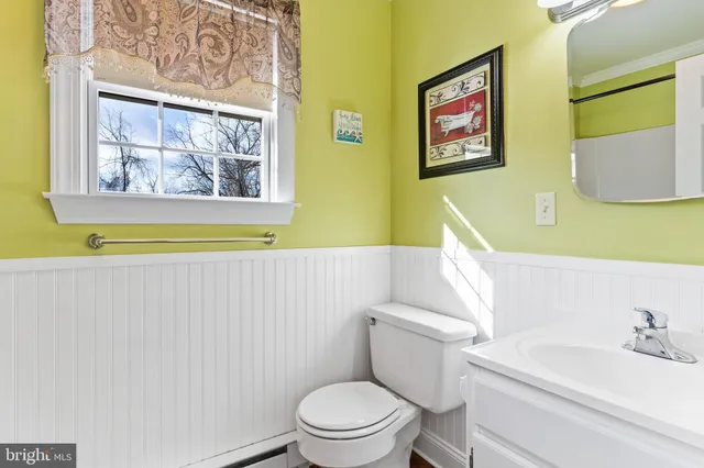 a view of empty room with wooden floor and windows