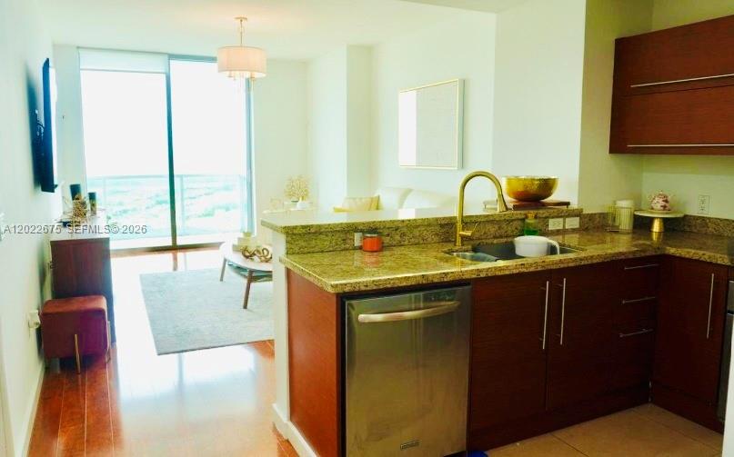 2681 North Flamingo Road, Unit 2602S Sunrise, FL 33323 - Photo 8 of 18 a kitchen with a sink and a wooden cabinets