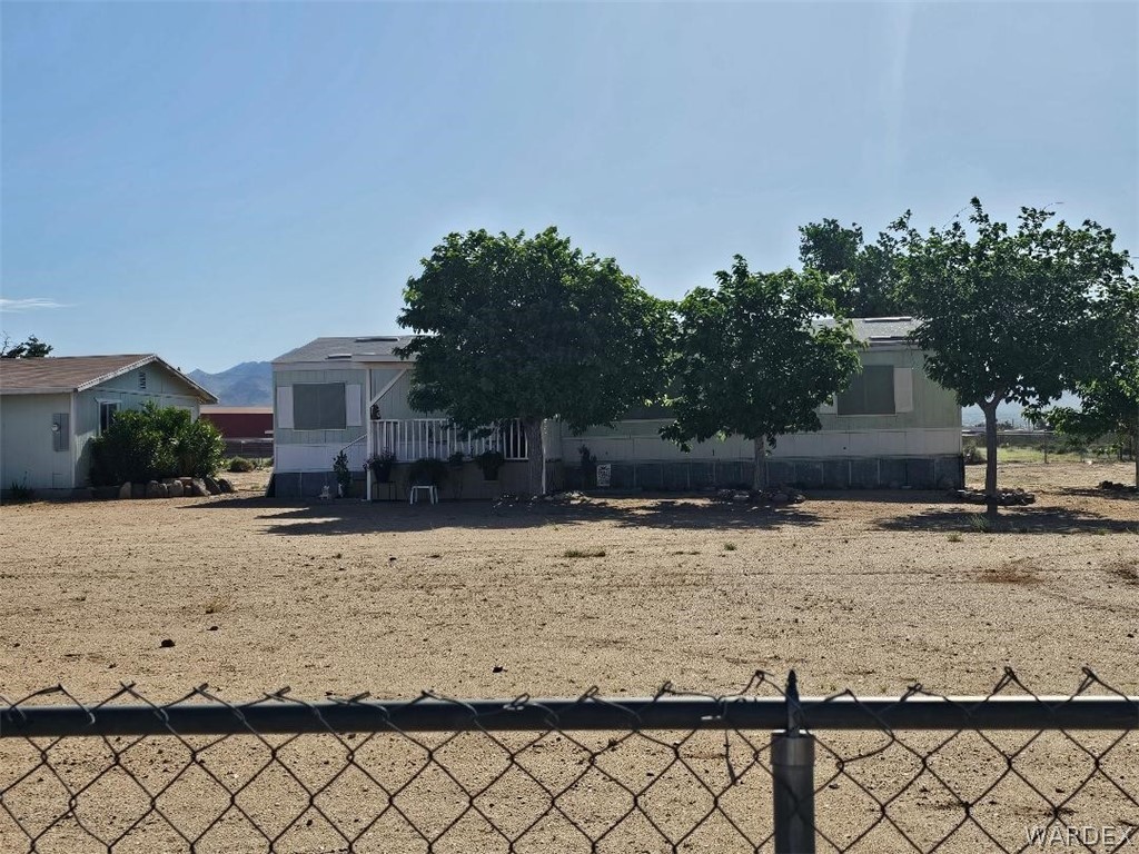 3552 Adobe Road Golden Valley, AZ 86413 - Photo 1 of 15 a view of a house with a yard covered with snow in the background