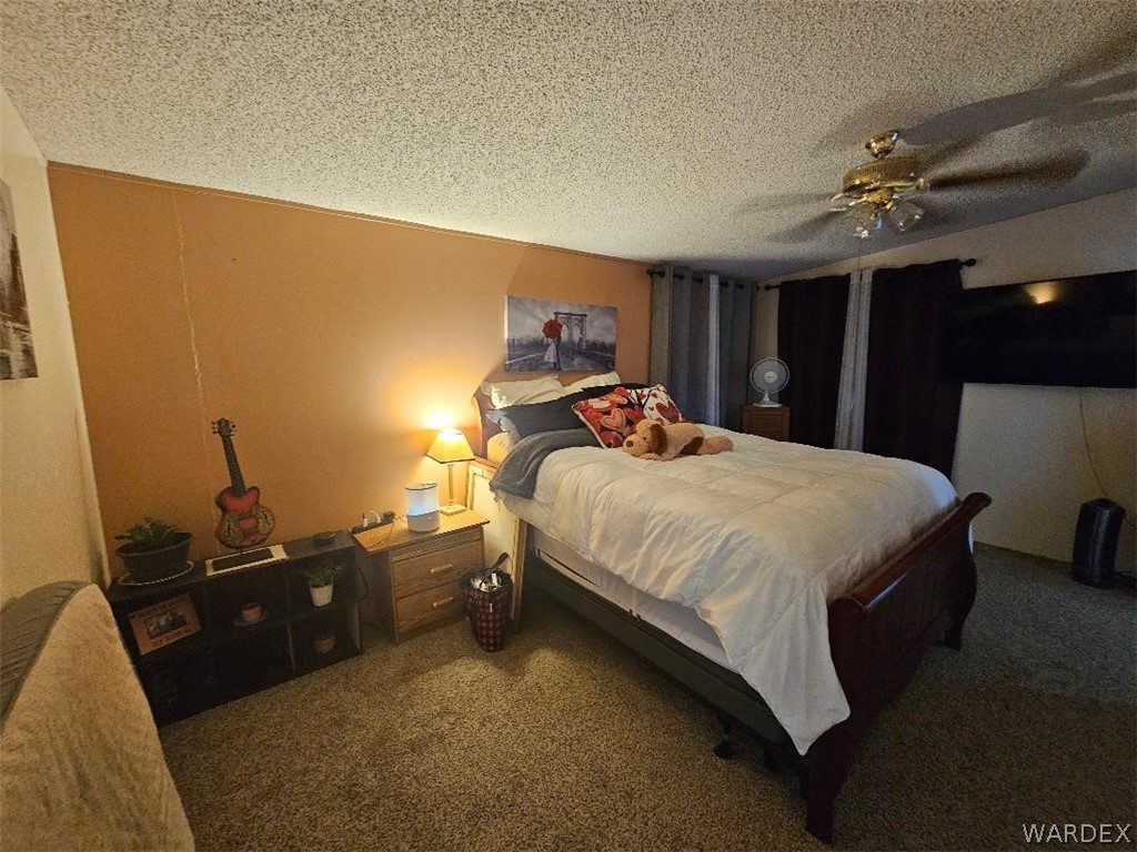 3552 Adobe Road Golden Valley, AZ 86413 - Photo 11 of 15 a bed sitting in a bedroom next to a window