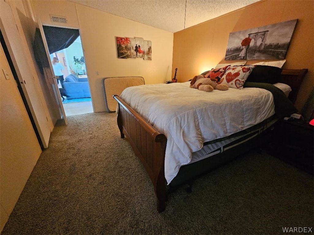 3552 Adobe Road Golden Valley, AZ 86413 - Photo 12 of 15 a bedroom with a bed rug and window