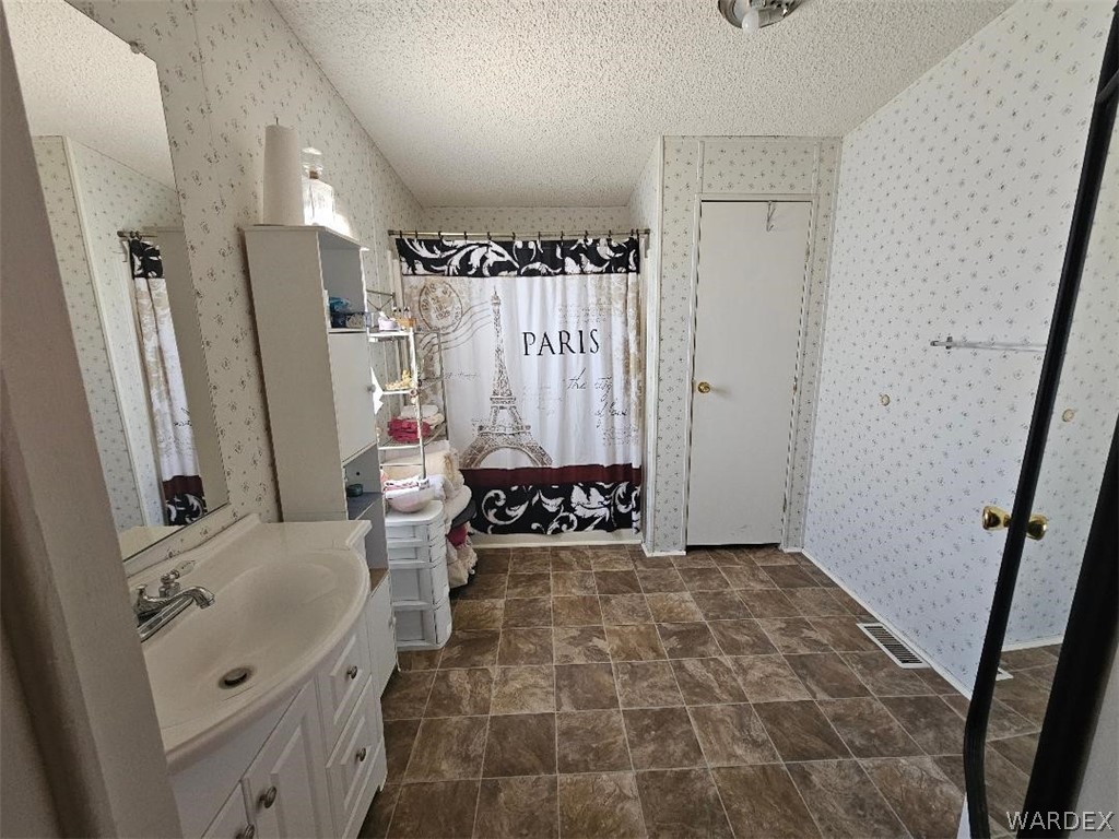 3552 Adobe Road Golden Valley, AZ 86413 - Photo 13 of 15 a bathroom with double vanity sink a mirror and shower