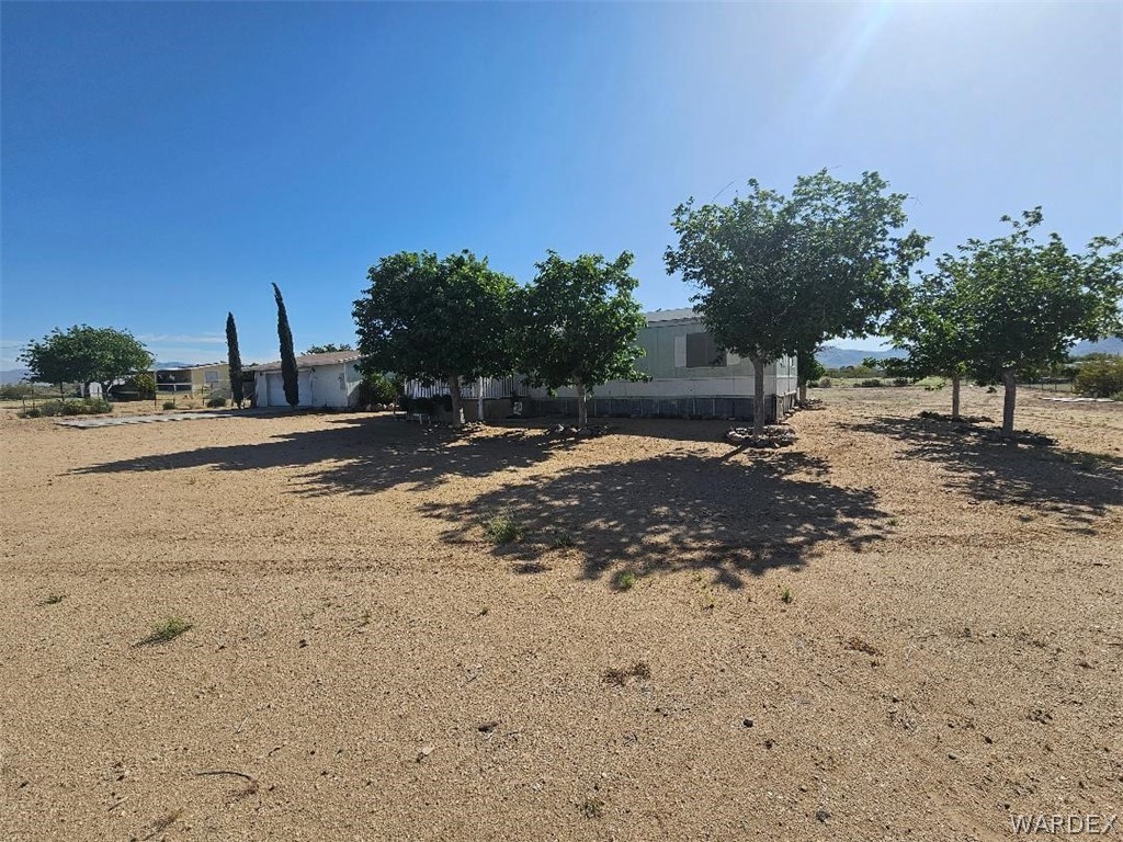 3552 Adobe Road Golden Valley, AZ 86413 - Photo 2 of 15 a view of a dirt road with a building in the background