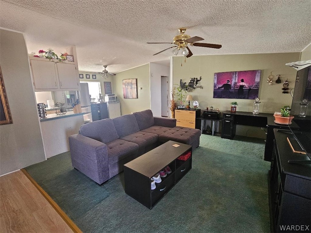 3552 Adobe Road Golden Valley, AZ 86413 - Photo 7 of 15 a living room with furniture and a flat screen tv