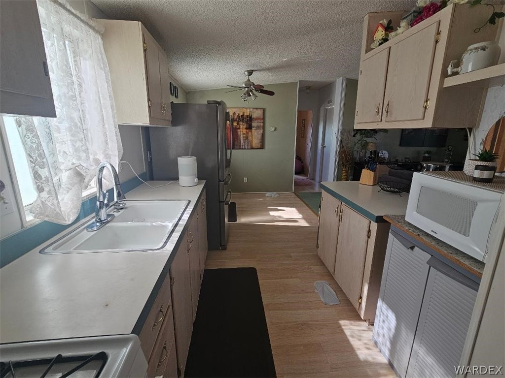 3552 Adobe Road Golden Valley, AZ 86413 - Photo 10 of 15 a kitchen with granite countertop a sink stove and refrigerator