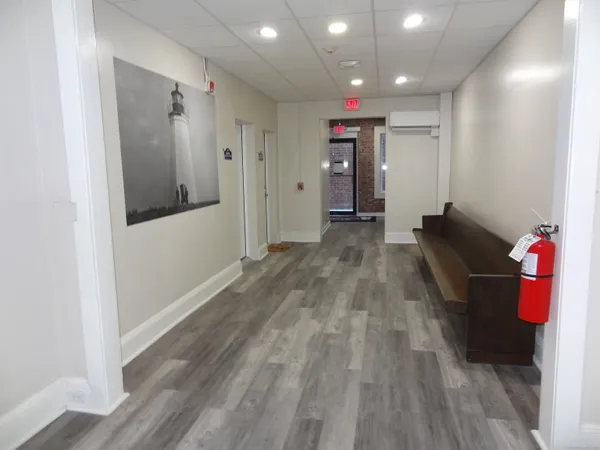 a view of hallway with wooden floor