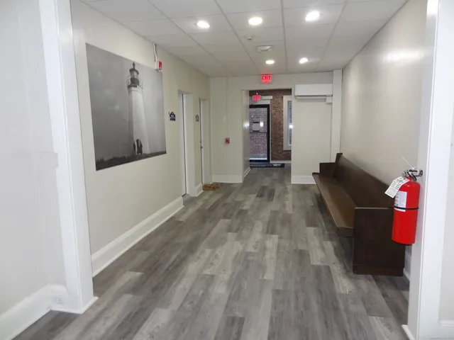 a view of hallway with wooden floor