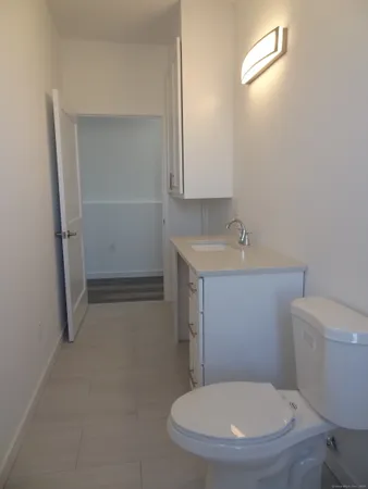 a white toilet sitting next to a bathroom sink