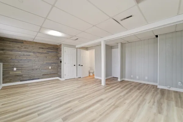 a view of an empty room with wooden floor