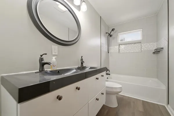 a bathroom with a sink a toilet and a mirror