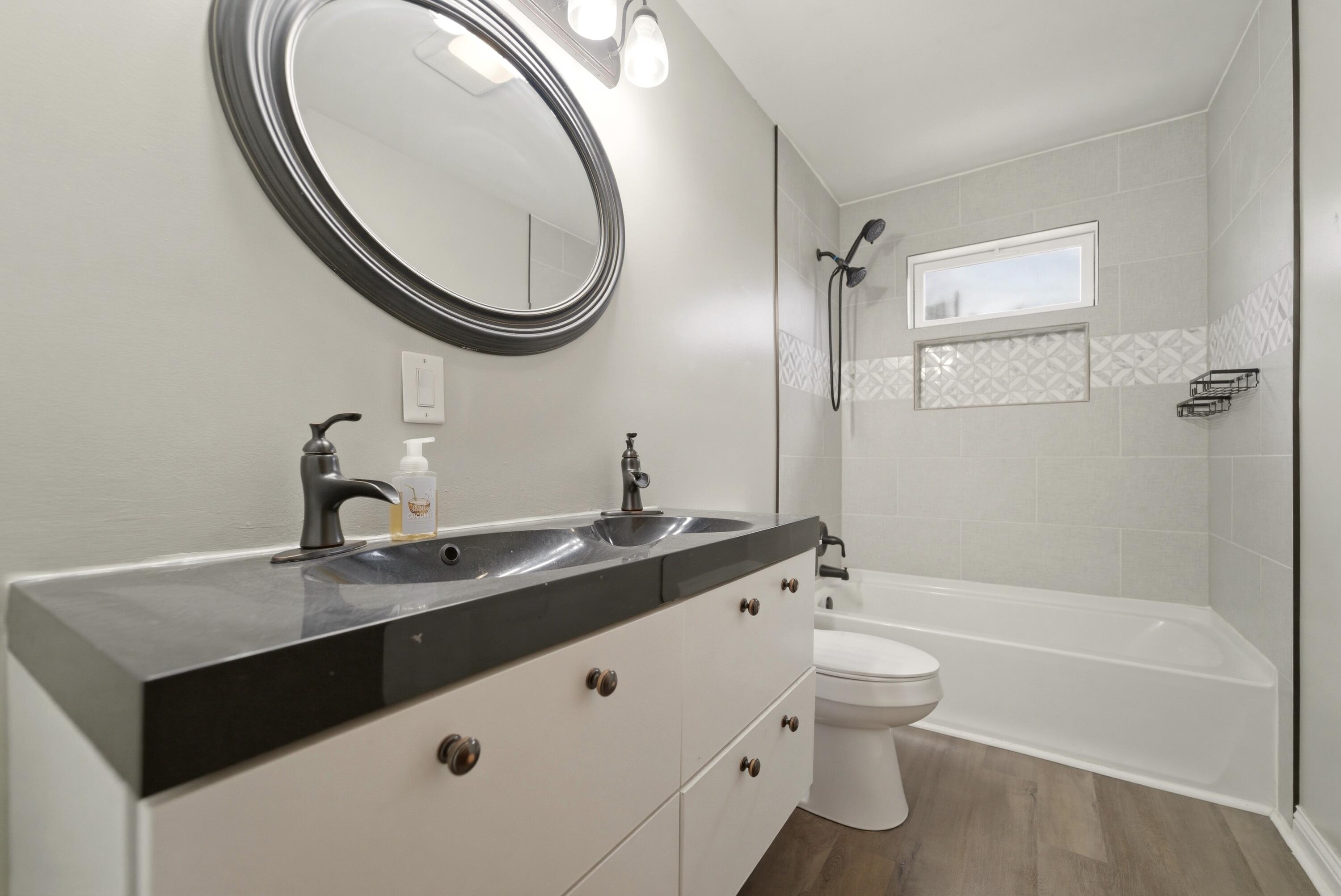 9830 Mckinley Street Crown Point, IN 46307 - Photo 16 of 25 a bathroom with a sink a toilet and a mirror