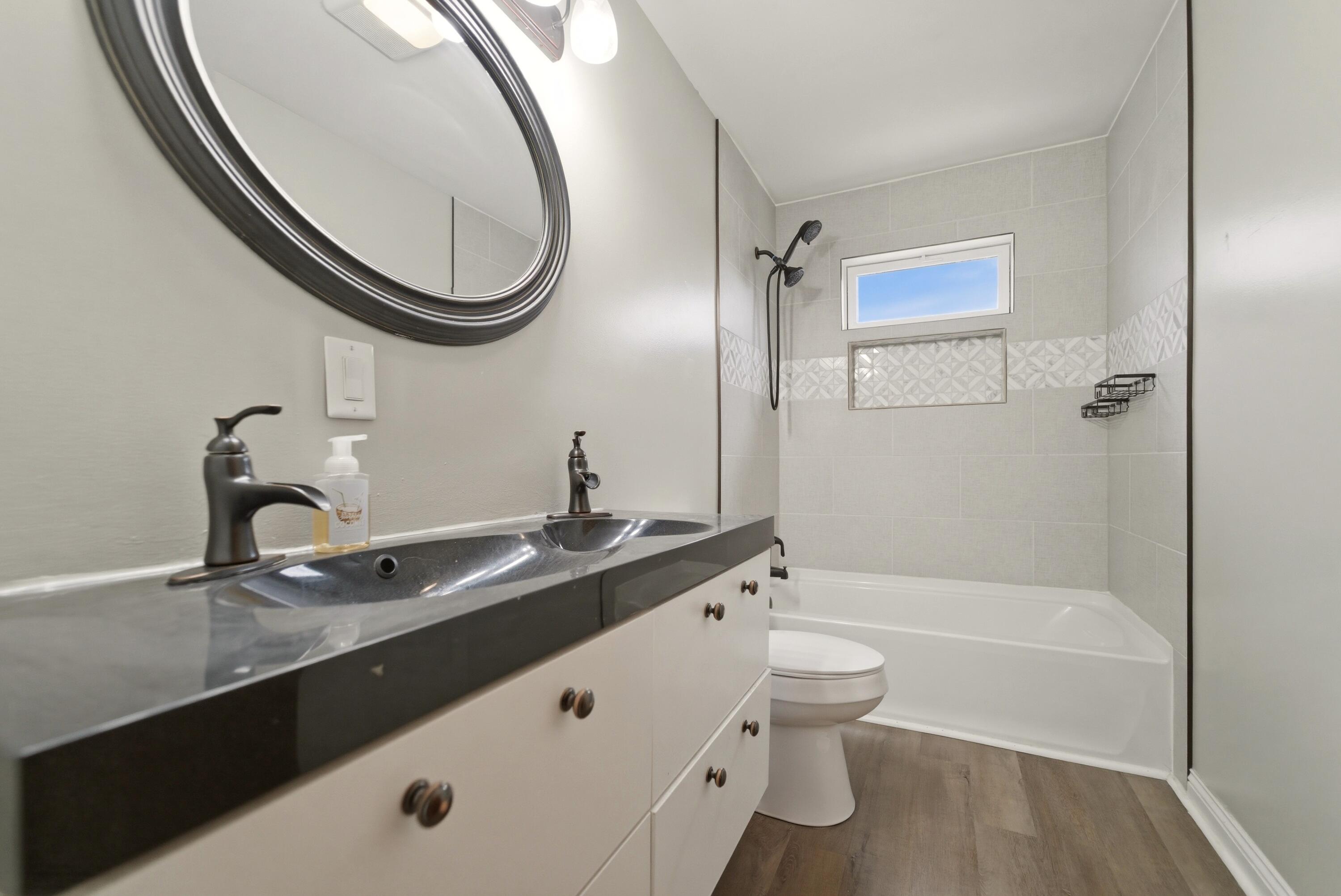 9830 Mckinley Street Crown Point, IN 46307 - Photo 17 of 25 a bathroom with a granite countertop sink a toilet and a mirror