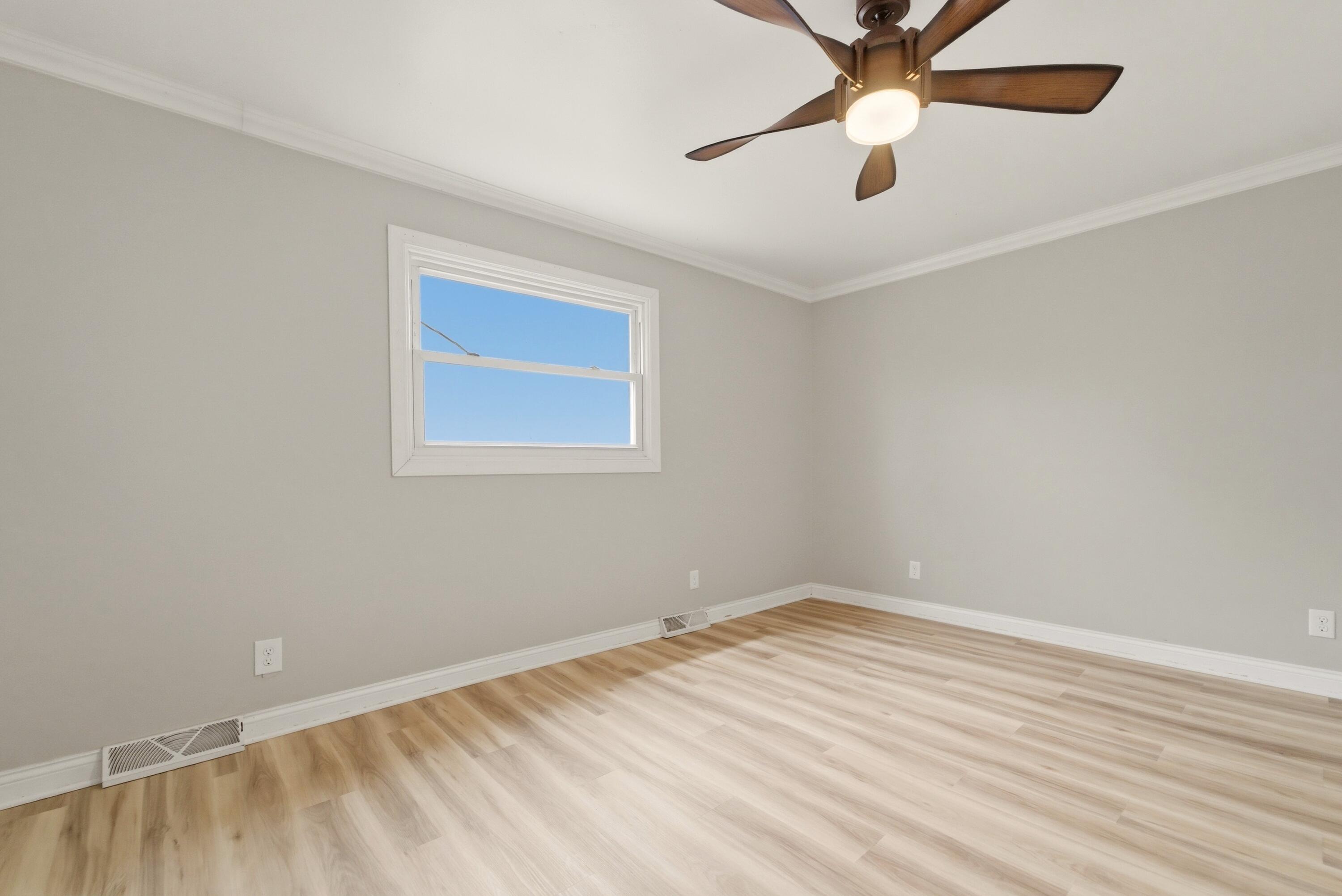 9830 Mckinley Street Crown Point, IN 46307 - Photo 18 of 25 an empty room with a window and a fan