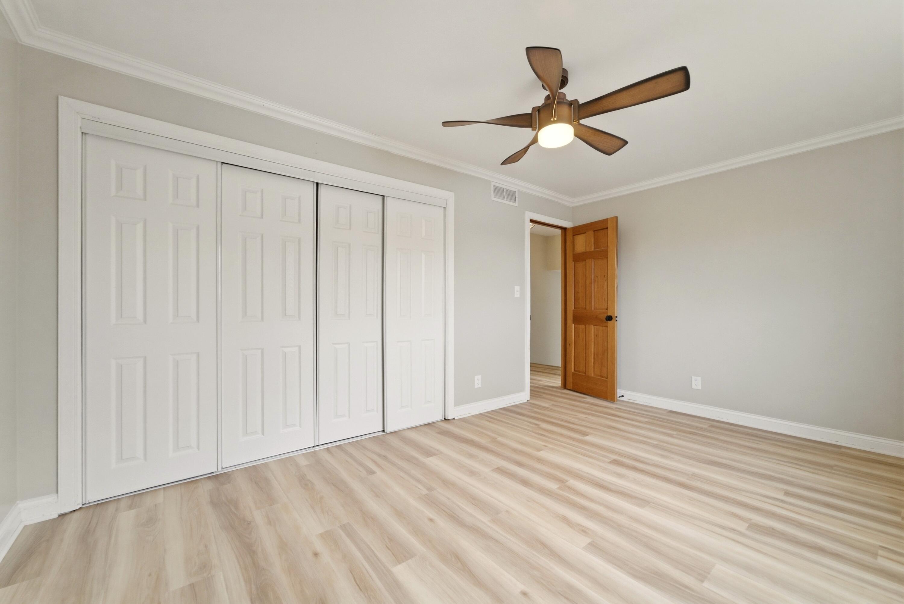 9830 Mckinley Street Crown Point, IN 46307 - Photo 19 of 25 a view of empty room with wooden floor and ceiling fan