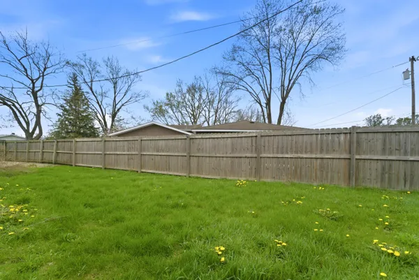 a view of a backyard with a fence