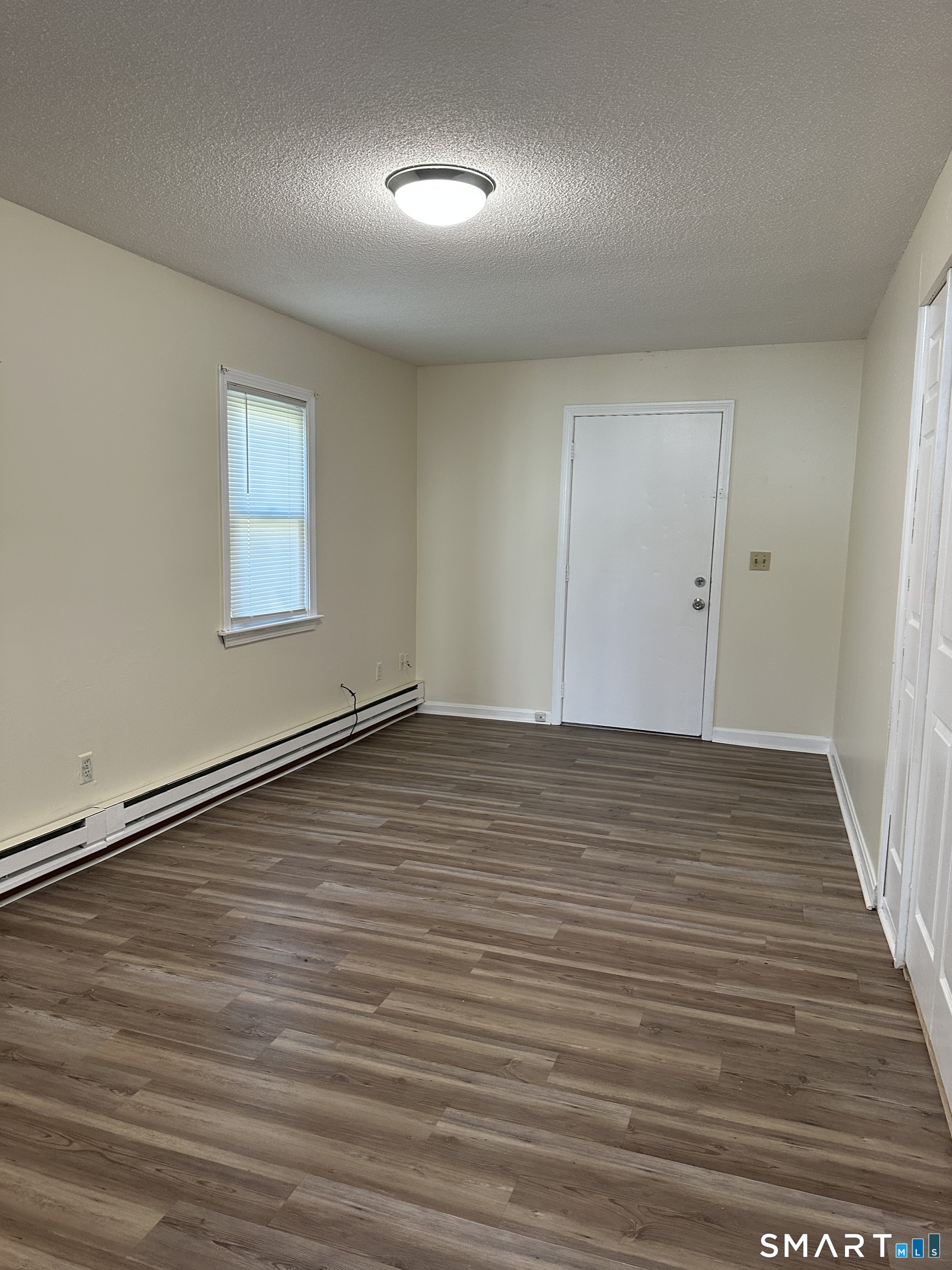 25-29 Locust Street New Britain, CT 06051 - Photo 3 of 5 wooden floor in an empty room