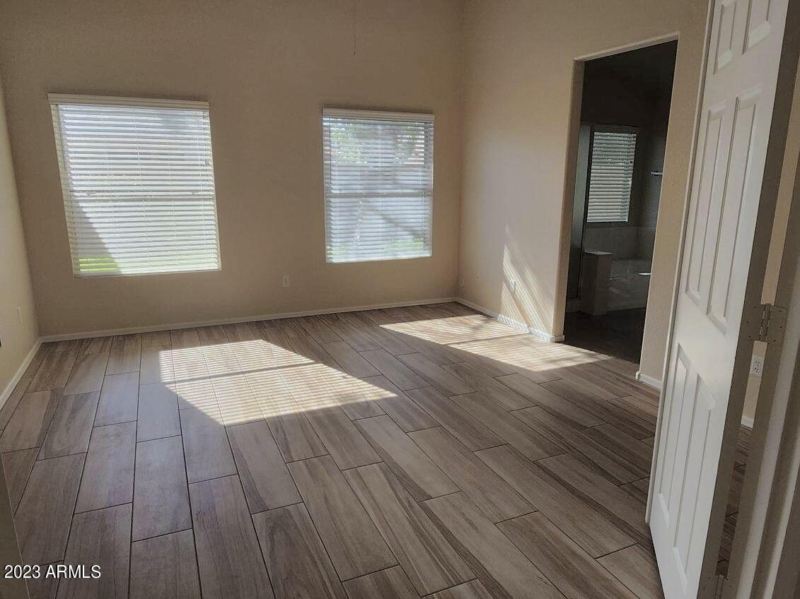 2642 South Augustine Mesa, AZ 85209 - Photo 11 of 18 an empty room with wooden floor and windows