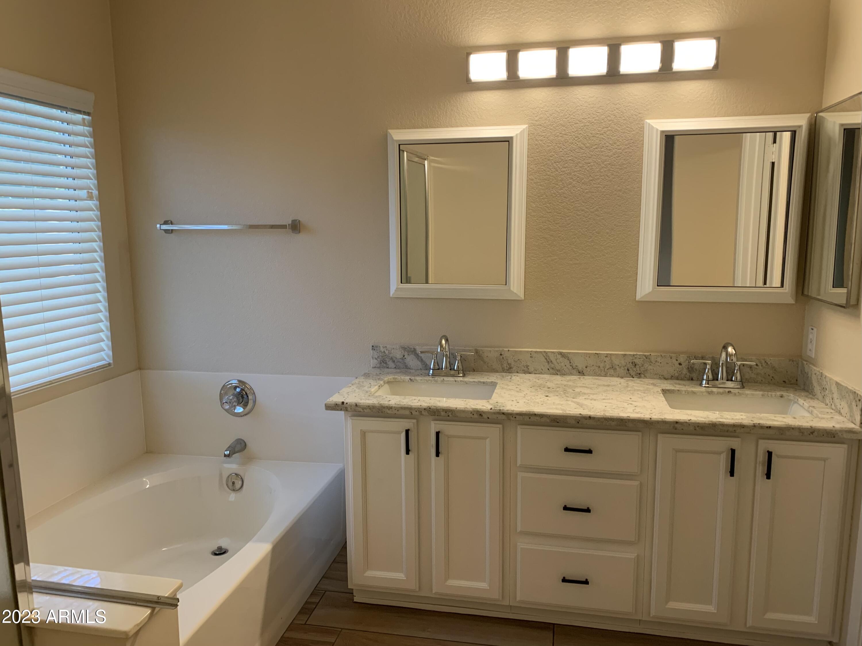 2642 South Augustine Mesa, AZ 85209 - Photo 12 of 18 a spacious bathroom with a granite countertop sink and a mirror