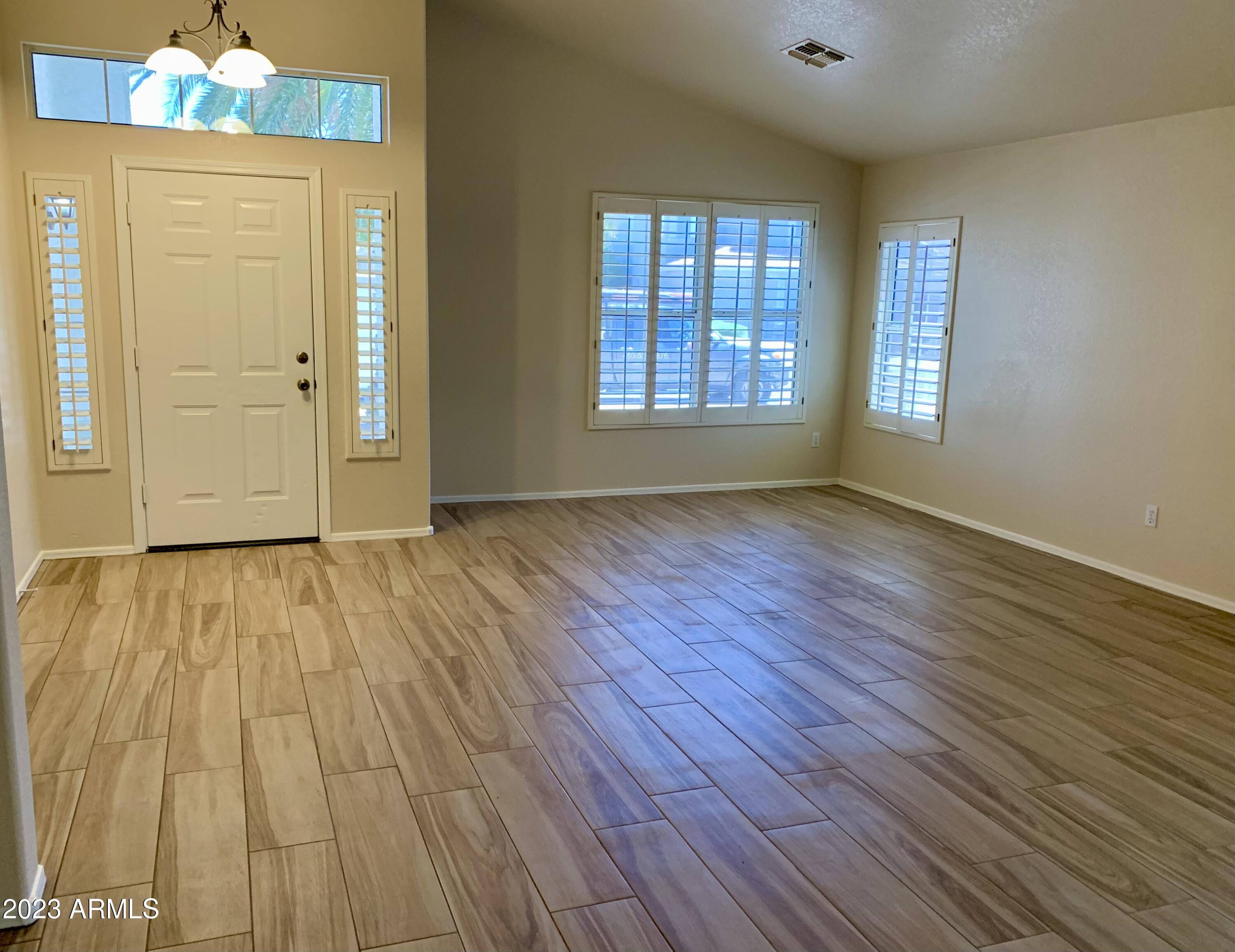 2642 South Augustine Mesa, AZ 85209 - Photo 2 of 18 an empty room with wooden floor and windows