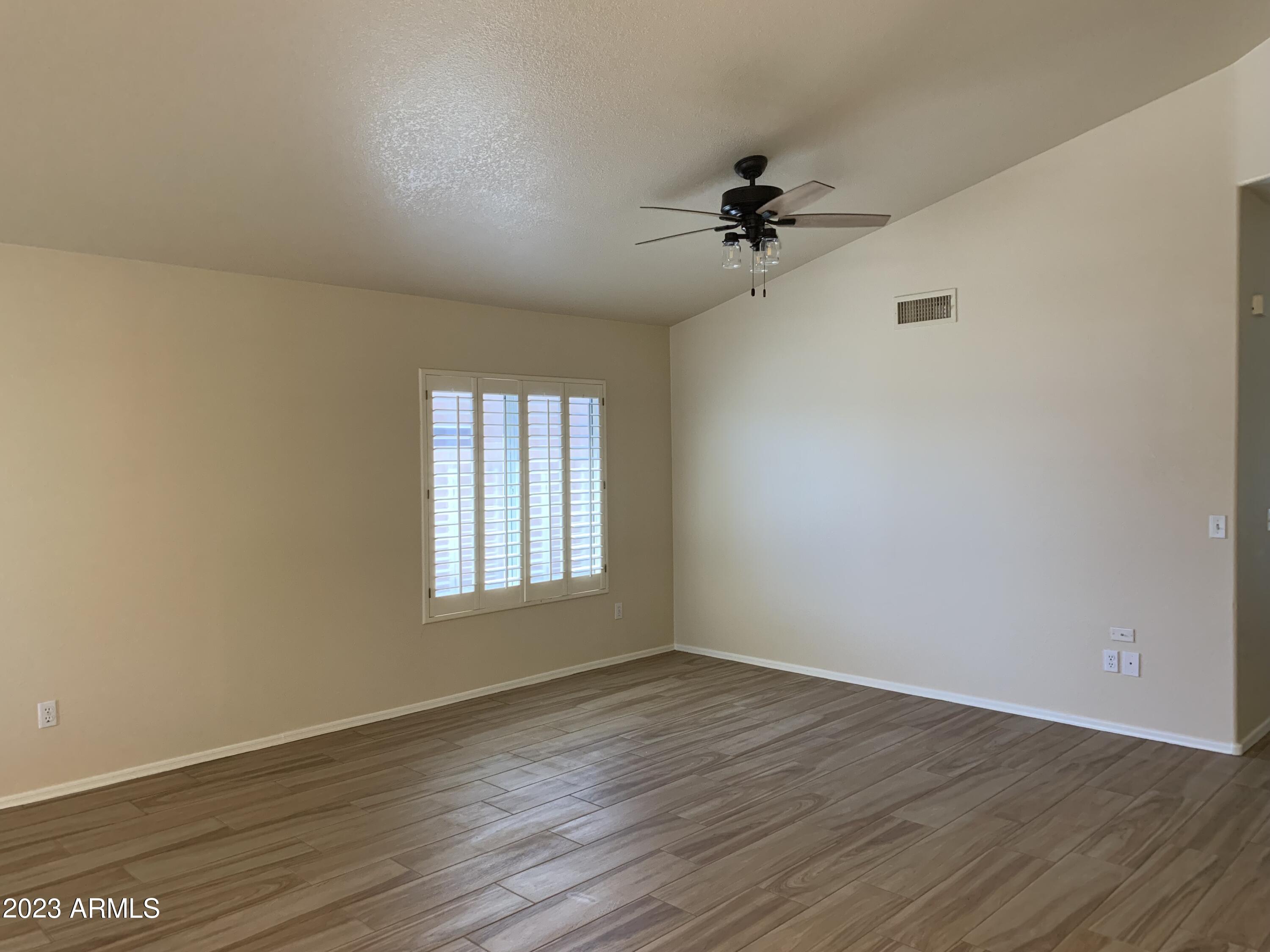 2642 South Augustine Mesa, AZ 85209 - Photo 3 of 18 wooden floor in an empty room with a window