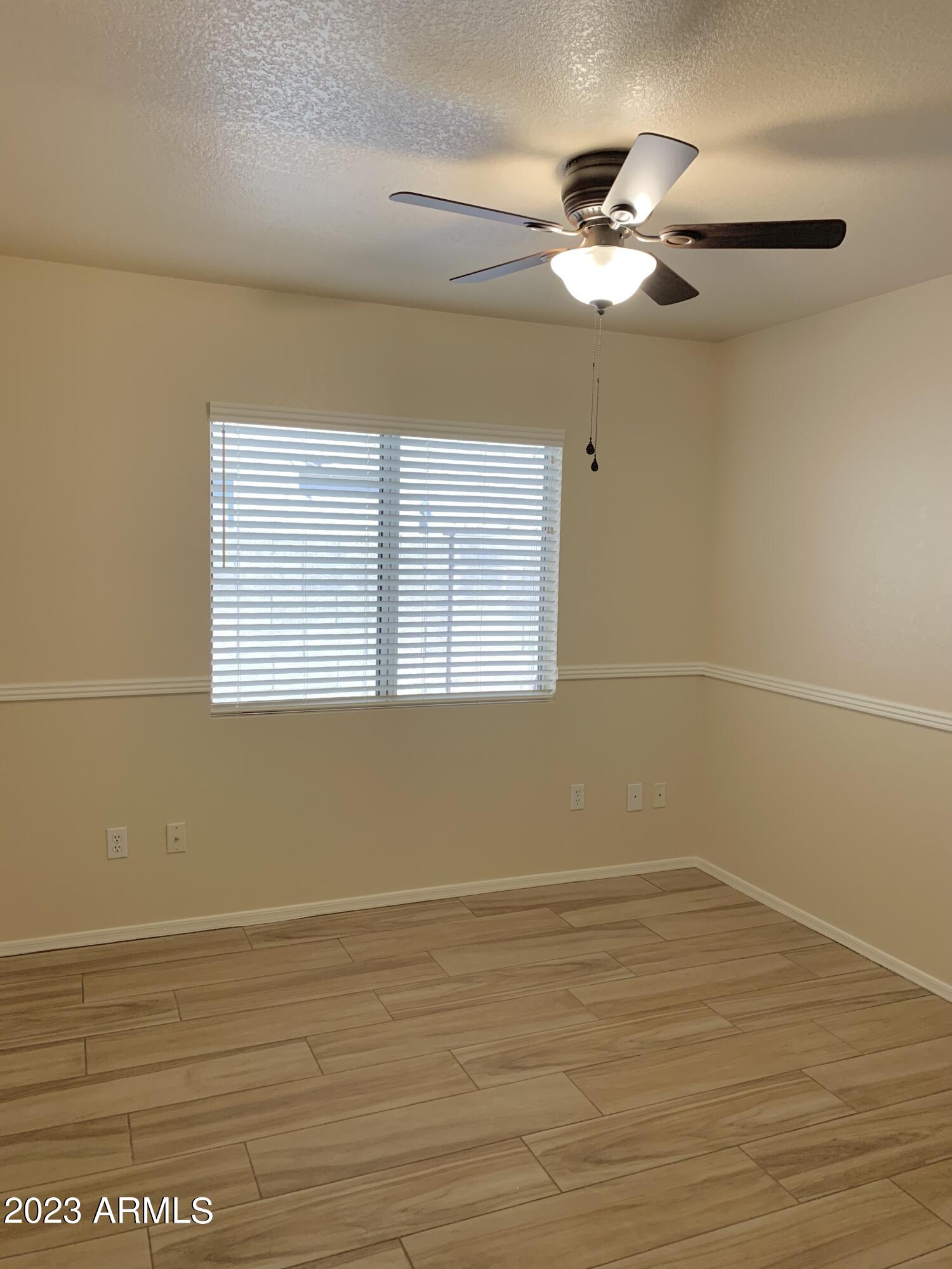 2642 South Augustine Mesa, AZ 85209 - Photo 8 of 18 a view of a room with wooden floor and a ceiling fan