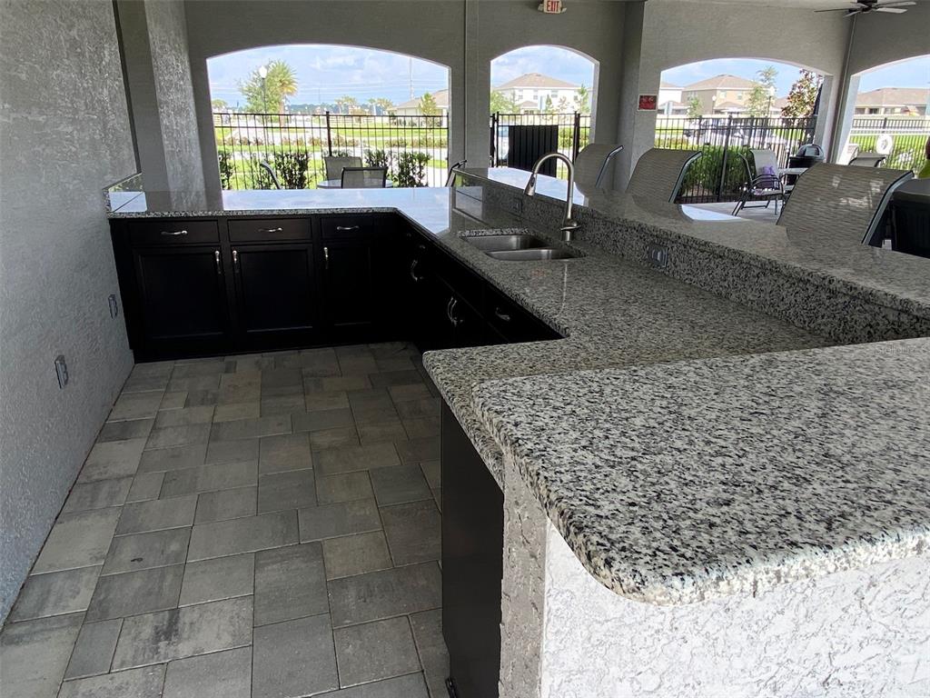 8864 Southwest 49th Circle Ocala, FL 34476 - Photo 45 of 48 a kitchen with stainless steel appliances a sink a counter space and a view of living room