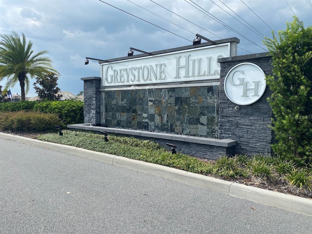 8864 Southwest 49th Circle Ocala, FL 34476 - Photo 48 of 48 a front view of a house with a garden and parking space