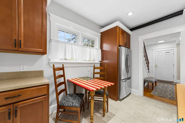 a kitchen with stainless steel appliances kitchen island granite countertop a refrigerator and a stove top oven
