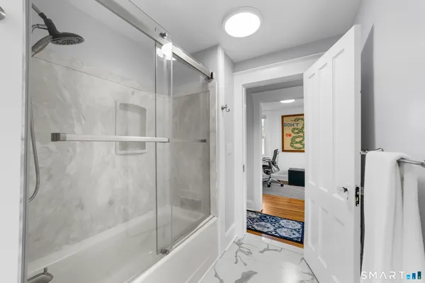 a bathroom with a bathtub and a shower