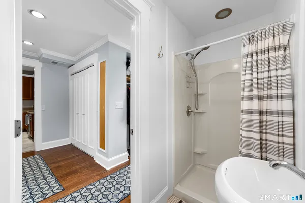 a bathroom with a sink a toilet a shower and a mirror