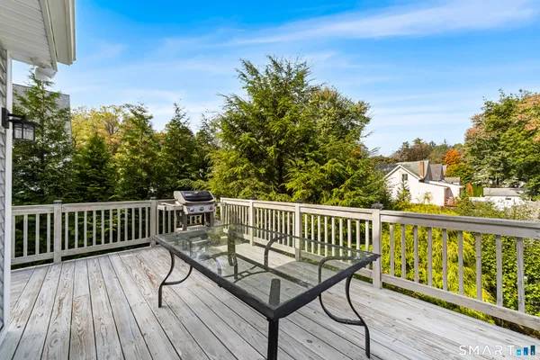 a front view of house with yard and trees in the background