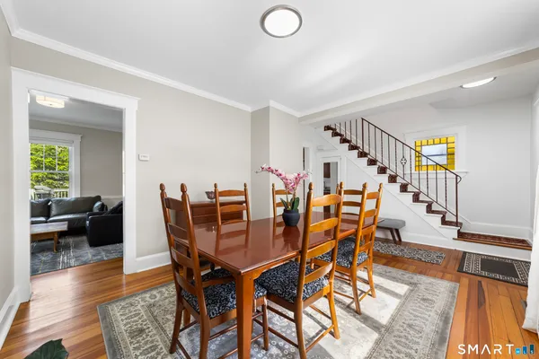 a dining room with furniture and wooden floor